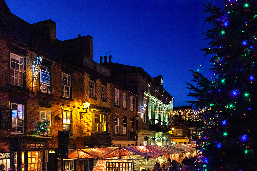 Photo of the Knaresborough Christmas Market at night with Christmas twinkly lights by local photographer Charlotte Gale